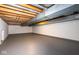 Spacious unfinished basement with an exposed ceiling and ductwork, as well as painted concrete walls and floor at 7027 Creekside Ln, Indianapolis, IN 46220
