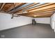 Unfinished basement space with exposed ceiling beams, ductwork, and painted concrete walls and floors at 7027 Creekside Ln, Indianapolis, IN 46220