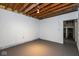 Unfinished basement with exposed ductwork and painted concrete walls and floor at 7027 Creekside Ln, Indianapolis, IN 46220