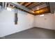 Unfinished basement has exposed ceiling and ductwork, as well as painted concrete walls and floor at 7027 Creekside Ln, Indianapolis, IN 46220