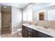 Bathroom with a double sink vanity, neutral tiling, and a walk-in glass shower nearby at 7027 Creekside Ln, Indianapolis, IN 46220