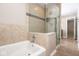 Elegant bathroom showcasing a modern glass shower, and a separate soaking tub for relaxation at 7027 Creekside Ln, Indianapolis, IN 46220