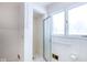 Clean bathroom showcasing white tile, a glass enclosed shower, and natural light from a window at 7027 Creekside Ln, Indianapolis, IN 46220