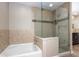 Elegant bathroom showcasing a modern glass shower, and a separate soaking tub for relaxation at 7027 Creekside Ln, Indianapolis, IN 46220