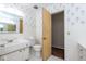 Charming vintage-style bathroom with white tile and quaint floral wallpaper at 7027 Creekside Ln, Indianapolis, IN 46220