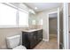 Bathroom featuring a double sink vanity with tiled flooring, plus a large bright window at 7027 Creekside Ln, Indianapolis, IN 46220