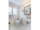 Tiled bathroom with toilet, sink, mirror and a window at 7027 Creekside Ln, Indianapolis, IN 46220