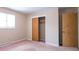 Bright bedroom featuring a window with natural light, a closet and two entry doors at 7027 Creekside Ln, Indianapolis, IN 46220