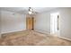 Open bedroom with tan carpet and a ceiling fan at 7027 Creekside Ln, Indianapolis, IN 46220