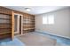 Bedroom with blue carpet, built in shelving, and a window for natural light at 7027 Creekside Ln, Indianapolis, IN 46220