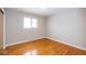 Bedroom featuring a large window, hardwood floors, and neutral walls at 7027 Creekside Ln, Indianapolis, IN 46220