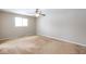 Bright bedroom with natural light from a window, complemented by beige carpeting at 7027 Creekside Ln, Indianapolis, IN 46220