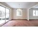 Bright dining room features a sliding glass door, large window and chandelier at 7027 Creekside Ln, Indianapolis, IN 46220