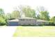 Charming brick home featuring a spacious front yard and attached two-car garage at 7027 Creekside Ln, Indianapolis, IN 46220