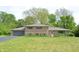 Charming brick home with well-manicured lawn and gray shutters at 7027 Creekside Ln, Indianapolis, IN 46220