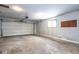 Spacious garage with a large overhead door, window, and concrete flooring at 7027 Creekside Ln, Indianapolis, IN 46220