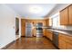 Spacious kitchen with stainless steel appliances, wooden cabinets and flooring at 7027 Creekside Ln, Indianapolis, IN 46220