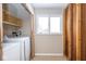 This laundry room is equipped with modern appliances and a window that offers natural light at 7027 Creekside Ln, Indianapolis, IN 46220