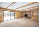 Inviting living room featuring a brick fireplace, sliding glass door, and built-in shelving at 7027 Creekside Ln, Indianapolis, IN 46220
