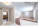 Open-concept living room with neutral tones and abundant natural light; kitchen access available at 7027 Creekside Ln, Indianapolis, IN 46220