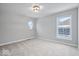 Spacious bedroom with neutral walls, plush carpeting, and an oval window at 12442 Coastal Pl, Fishers, IN 46037