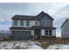 Two-story home with gray and white color scheme, attached garage, and snowy front yard at 1853 Grand Vista Blvd, Greenwood, IN 46143