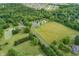 Aerial view showcasing home with pool, pond, and lush greenery, set on a sprawling and picturesque lot at 3592 W Smokey Row Rd, Bargersville, IN 46106