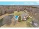 Aerial view showcases home with pool, pond, and outbuilding, set on a sprawling and picturesque lot at 3592 W Smokey Row Rd, Bargersville, IN 46106