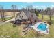 Aerial view of the home with large deck and pool, surrounded by mature trees at 3592 W Smokey Row Rd, Bargersville, IN 46106