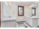 Bathroom with double sinks, vanity with white cabinets, tile floor, framed mirror, and a window at 3592 W Smokey Row Rd, Bargersville, IN 46106