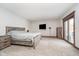 A spacious bedroom featuring carpeted floors, a large window and a minimalist style at 3592 W Smokey Row Rd, Bargersville, IN 46106