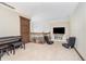 Bonus room features carpeted floors, a TV, and two gaming chairs for entertainment and relaxation at 3592 W Smokey Row Rd, Bargersville, IN 46106
