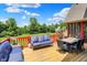Wood deck includes built in couches and a dining table, offering stunning views of the surrounding landscape at 3592 W Smokey Row Rd, Bargersville, IN 46106