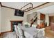 Dining room features a fireplace, wood trim, a modern light fixture, and a table with seating for six at 3592 W Smokey Row Rd, Bargersville, IN 46106