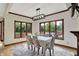 Bright dining room features three large windows, wood trim, a modern light fixture, and seating for six at 3592 W Smokey Row Rd, Bargersville, IN 46106