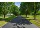 Long, paved driveway lined with mature trees leading to the property at 3592 W Smokey Row Rd, Bargersville, IN 46106