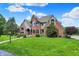 Stately brick home with manicured lawn and mature trees on a sunny day at 3592 W Smokey Row Rd, Bargersville, IN 46106