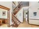 Inviting foyer featuring hardwood floors, detailed molding, and a carpeted staircase at 3592 W Smokey Row Rd, Bargersville, IN 46106