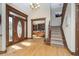 Elegant foyer with hardwood floors, grand staircase, and wooden front door at 3592 W Smokey Row Rd, Bargersville, IN 46106