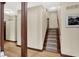 Spacious hallway with wood floors, decorative columns and staircase leading to upper floor at 3592 W Smokey Row Rd, Bargersville, IN 46106