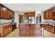 Bright kitchen features stainless steel appliances, wood cabinets, light countertops, and a breakfast bar island at 3592 W Smokey Row Rd, Bargersville, IN 46106