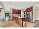 Bright kitchen features stainless steel appliances, wood cabinets, light countertops, and a breakfast bar island at 3592 W Smokey Row Rd, Bargersville, IN 46106