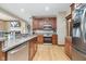 Kitchen featuring granite countertops, stainless steel appliances, wood cabinets, and hardwood flooring at 3592 W Smokey Row Rd, Bargersville, IN 46106