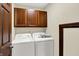 Functional laundry room with a washer, dryer, and upper cabinets for storage at 3592 W Smokey Row Rd, Bargersville, IN 46106