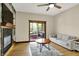 Living room features a fireplace, wood floors, access to a screened in porch, and comfortable seating at 3592 W Smokey Row Rd, Bargersville, IN 46106