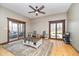 Cozy living room featuring a ceiling fan, area rug, and sliding door to the porch at 3592 W Smokey Row Rd, Bargersville, IN 46106