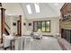 Bright living room featuring a brick fireplace, skylights, and ample natural light from the large window at 3592 W Smokey Row Rd, Bargersville, IN 46106