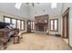 Cozy living room featuring a fireplace, grand piano, large windows, and a ceiling fan at 3592 W Smokey Row Rd, Bargersville, IN 46106