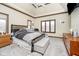 Spacious main bedroom featuring a ceiling fan, wood trim, carpet, and windows overlooking the outdoors at 3592 W Smokey Row Rd, Bargersville, IN 46106