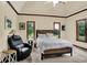 Comfortable bedroom with a tray ceiling, plush chair, natural light, and a cozy atmosphere at 3592 W Smokey Row Rd, Bargersville, IN 46106